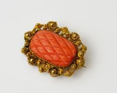 A superb, very finely made Georgian lace pin/brooch. This outstanding piece of jewellery dates back to Georgian era and was made circa 1800-1820. Finely carved coral in the pineapple style that was in vogue at the time is surrounded by intricate cannetille gold work. Gold is unmarked, but tested and confirmed to be 18 ct. Coral - is high quality natural coral, undyed, deep orangey-red in colour. Dimensions: 29х22 мм. Condition: perfect, both coral and gold work is in fine order, with no faults, the old-type c-clasp and the needle are original and in in fine working order. Georgian Era, Coral And Gold, Natural Coral, Gold Work, Gold Lace, Pin Brooch, Brooch Pin, Brooches, Pineapple