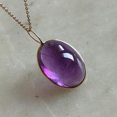 This stunning Pendant is set in 14k Solid Yellow Gold with Natural Purple Amethyst with utmost precision. It is a unique gemstone Pendant for nearly every occasion and is completely hassle-free jewelry. ITEM DETAILS: * Gem: Purple Amethyst * Gem Size: 15x20mm * Gem Shape: Oval Fix Loop * Gem Weight: 18.60 carats * Gold Purity: 14KT  * Gold Weight: 0.41 gram * Total Weight of the Pendant: 4.13 gram The Gold purity is guaranteed and it comes with authentic 14KT gold hallmark. Since my items are ha Elegant Cabochon Amethyst Gemstones, Elegant Amethyst Cabochon Gemstones, Yellow Gold Briolette Gemstones For Formal Occasions, Formal Amethyst Oval Cabochon Jewelry, Formal Amethyst Jewelry, Oval Cabochon, Formal Yellow Gold Briolette Gemstones, Polished Amethyst Gemstones For Formal Occasions, Yellow Gold Polished Oval Cabochon Gemstones, Polished Yellow Gold Oval Cabochon Gemstones