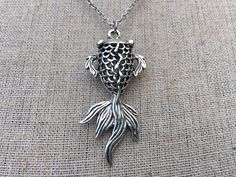 "This is such a fun and whimsical koi fish pendant necklace! It has incredible detail and makes a unique statement piece of jewelry. Simply stunning! The koi fish pendant measures 1 1/2\" long by 3/4\" wide and hangs from a stainless steel 18\" chain necklace with a lobster clasp. Thanks for stopping by! Please take a moment and visit the rest of my Etsy shop. I have many more unique jewelry designs to choose from! 🌸 Tiger Flower Jewelry 🌸 🌸Inspired by Nature 🌸" Fish-shaped Metal Jewelry For Gifts, Fish-shaped Metal Jewelry As A Gift, Tiger Flower, Fish Gifts, Unique Fish, Fish Pendant Necklace, Fish Jewelry, Fish Necklace, Fish Pendant