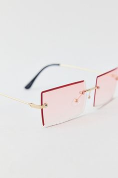 Candy-colored rimless rectangle sunglasses for a sugar-sweet look. Features Sammi rimless rectangle sunglasses Wire sunglasses Rectangle rimless lenses 100% UV protection Content + Care Plastic, mixed metal Wipe clean Imported | Sammi Rimless Rectangle Sunglasses in Pink, Women's at Urban Outfitters Sunglasses Rectangle, Wire Sunglasses, Pink Rectangle, Graphic Tee Dress, Pink Sunglasses, Pink Fits, Rectangle Sunglasses, Brand Sale, Mixed Metals