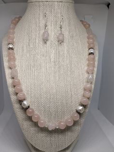 "This set is very pretty. It is made of 10mm rose quartz round beads, 6x10 mm dog bone rose quartz beads, 4mm bicone clear crystals and approx. 8 x 10 genuine white cultured pearls. The necklace measures 22\" (inches) end to end. It is finished with a silver plated toggle clasp.  The earrings are made of the rose quartz dog bone bead with 4mm crystals. It hangs 1. 1/16 of an inch just below the ball of the silver plated French wire  The rose quartz is a very pretty pale pink which I was having trouble trying to get with my camera. I ship USPS so that your package will arrive safe and sound in only a few days!  Satisfaction is always guaranteed!  You can email me at  lynnsattic@gmail.com or convo me with any suggestions, questions, ideas or comments.  I'm always very happy to hear from you! Pink Pearl Jewelry With 8mm Beads, White Rose Quartz Jewelry With 8mm Beads, Elegant Rose Quartz Round Beaded Jewelry, Elegant Beaded Rose Quartz Jewelry, Elegant Round Rose Quartz Bead Jewelry, Elegant Rose Quartz Beaded Jewelry, White Rose Quartz Jewelry For Jewelry Making, Elegant Jewelry With 8mm Beads For Mother's Day, Elegant 8mm Beads Jewelry For Mother's Day