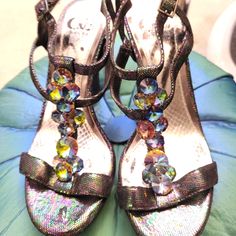 Black Iridescent Embellished Platform High Heel Sandals, 7.5 M. These Fabulous Sandals Have 4.5 Inch Heels. A 3/4 Inch Platform, Coveted By Iridescent Multicolored Hologram Like Blue, Green And Purple Speckled Leather. The Upper Has A Toe And Double Ankle Strap As Well As A Heel Strap, With Iridescent Gems On The T-Strap Front Strap That Connects The 2 Ankle Straps. Shoes Were Never Worn, And Have Think Padding On Insoles. Fabulous Party Shoes Or For A Dress Up Event, Although They'd Look Great Multicolor High Heel Sandals With Rhinestones, Multicolor Rhinestone High Heel Sandals, Multicolor Embellished Evening Sandals, Embellished Multicolor Evening Sandals, Evening Multicolor Embellished Sandals, Multicolor Embellished Heels For Formal Occasions, Elegant Embellished Multicolor Sandals, Elegant Multicolor Embellished Sandals, Iridescent Open Toe Sandals For Party