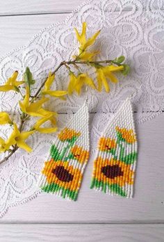 the beaded sunflowers are next to some yellow flowers