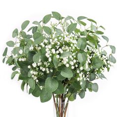 a vase filled with white flowers and greenery