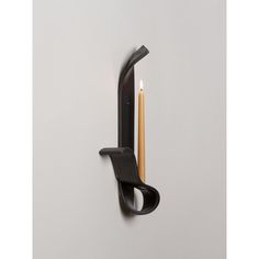 a wall mounted candle holder with a wooden stick sticking out of it's side