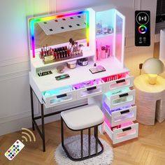 an illuminated makeup vanity with drawers and stools on the floor next to a remote control