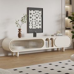 a living room scene with focus on the entertainment center and potted plant in the corner