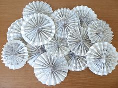 several paper fans sitting on top of a wooden table