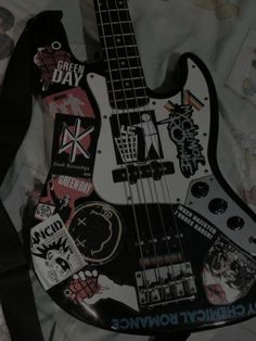 a black and white guitar with stickers on it