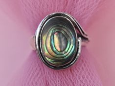 Elevate your style with our Abalone Shell Sterling Silver Ring in size 5 1/2 US. This enchanting piece is the perfect addition to your jewelry collection, blending a touch of boho chic with a hint of sophistication. Handcrafted by skilled artisans, the vibrant abalone shell centerpiece adds a pop of color and a touch of nature's beauty to your look. Whether you're dressing up for a special occasion or adding a unique twist to your daily outfit, this statement ring is a must-have. Surprise a love Silver Shell-shaped Bohemian Jewelry, Unique Silver Shell Rings, Silver Bohemian Shell Jewelry, Bohemian Silver Shell Jewelry, Iridescent Round Bohemian Jewelry, Unique Iridescent Oval Jewelry, Unique Oval Iridescent Jewelry, Bohemian Iridescent Round Jewelry, Silver Shell Rings For Gift