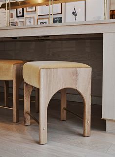 two wooden stools sitting next to each other on top of a hard wood floor