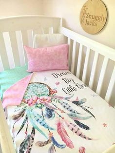 a baby crib bed with pink and blue sheets