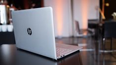 an open laptop computer sitting on top of a table