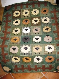 a quilted sheep blanket sitting on top of a table