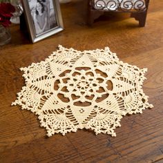 a wooden table topped with a white doily