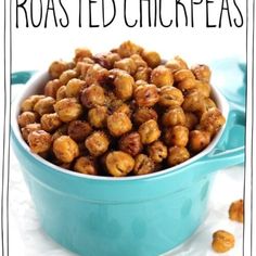 a blue bowl filled with roasted chickpeas on top of a white tablecloth