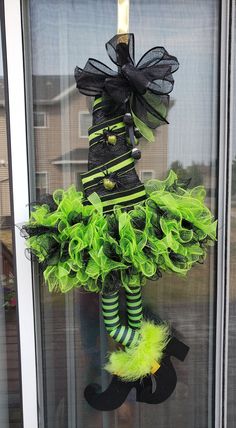 a green and black costume hanging on a door