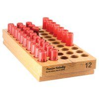 a wooden game board with red plastic cups on it and two rows of holes in the middle