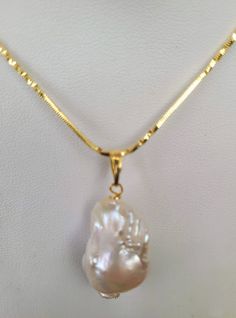 Baroque pearl pendant 30mm x 20mm (approx.) with gold plated bail. Due to uniqueness of beads shapes may differ slightly. Chain is not included. We aim to please. You will be happy with your pearl if you love baroque! You can ask for images of shapes we have available. Gold Pearl Necklace With Large Pendant, Unique Gold Pendant Pearl Necklace, White Pearl Necklace With Large Pendant, Beads Shapes, Baroque Pearl Pendant, Baroque Pearls, Pearl Pendant, Gold Plate, Beads