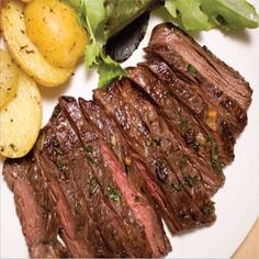 steak, potatoes and lettuce on a plate