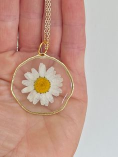 Real white dried daisy flower necklace pressed in resin.   Comes in gold or silver plated & 2 lengths, 16 inch & 18 inch Delicate White Daisy-shaped Jewelry, White Birth Flower Round Pendant Necklace, White Birth Flower Necklace, White Flower Charm Necklace, Gold Necklaces With Pressed Flowers And Adjustable Fit, Adjustable Gold Necklace With Pressed Flowers, White Flower Pendant Necklace With Pressed Flowers, Dainty White Round Flower Necklace, Elegant White Pressed Flower Necklace