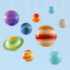 the solar system with eight planets hanging from it's strings in front of a blue sky