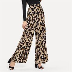 These leopard print pants bring some fabulous flare to your wardrobe. Featuring a mid-waist and fared legs with a flat front. These pants pair perfectly with a bodysuit, blouse or sweater; perfect in and out of the office. Made with a polyester blend for comfort and style. Chic Leopard Print Pants For Work, Chic Leopard Print Workwear Bottoms, Trendy Leopard Print Pants For Work, Leopard Print High Waist Bottoms For Work, High Waist Leopard Print Bottoms For Work, Chic Leopard Print Bottoms For Fall, Leopard Print Wide Leg Bottoms For Work, Wide Leg Leopard Print Bottoms For Work, Workwear Wide Leg Leopard Print Bottoms