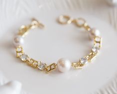 This beautiful bracelet is made from 3 Edison Pearl and good quality gold components. Each of Pearl carefully hand wired in 14k gold filled and the bracelet finished with a simple toggle. The Pearl size is between 10-11mm colour in white with great lustre. The pictures do not do this bracelet justice Let this unique piece be a perfect accessory for your everyday adventures or a gift to the loved one.  The length of bracelet can be adjustable up to 19cm. Because each item is handmade there may be Elegant Gold Bracelet With Hypoallergenic Round Beads, Gold Pearl Chain Bracelet Gift, Elegant Hypoallergenic Gold Bracelet With Round Beads, Elegant Hypoallergenic Gold Bangle Bracelet, Elegant 14k Gold-filled Bracelet, Elegant 14k Gold Filled Bangle Bracelet, White Gold Plated Bracelets For Wedding, White Gold Plated Bracelet For Wedding, Elegant Gold Pearl Bracelet Hypoallergenic