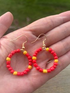 Handcrafted hoops earrings made with vibrant red gold and white beads, perfect for adding a pop of color to any outfit. Lightweight and comfortable to wear.  Material 25mm hoops 14k plated  beaded Color  Red Gold White Football Earrings, Hoops Earrings, Earrings Red, Beaded Hoops, Handcrafted Earrings, White Beads, Kansas City Chiefs, Jewelry Earrings Hoops, Vibrant Red