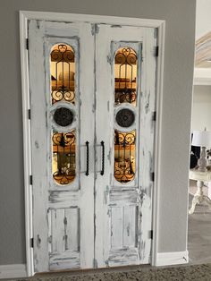 two white double doors with stained glass