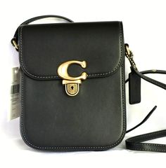 COACH Smooth Black Leather Small Tall Crossbody Shoulder Bag Brass  Style No. CA057  Retails new for $250.00 NEW with attached tag  THERE ARE A COUPLE OF MARKS ON FRONT DUE TO STORING & SOFTNESS OF LEATHER (SEE PICS) Black glovetanned leather with brass tone hardware  Three credit card slots & a Coach hangtag  Pushlock closure Interior is fabric lining in a golden tan color  Outside open bakc pocket Adjustable strap with 21 1/2" drop for shoulder or crossbody wear A small size bag measuring 5 1/ Coach Formal Shoulder Bag With Mobile Phone Pocket, Coach Formal Mobile Phone Shoulder Bag, Coach Leather Shoulder Bag With Mobile Phone Holder, Coach Leather Mobile Phone Shoulder Bag, Coach Leather Shoulder Bag For Mobile Phone, Dream Bags, Golden Tan, Top Shelf, Tote Backpack