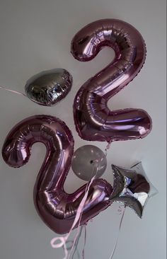 balloons and streamers are arranged in the shape of the number twenty five on a white background