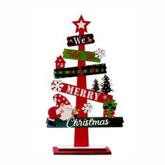 a christmas tree made out of wooden signs with santa claus and other decorations on it