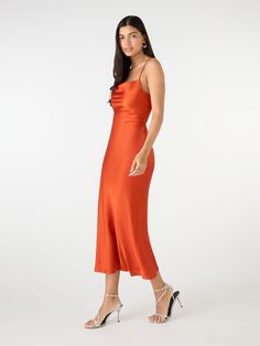 Our best-selling Riviera in heatwave Brick Orange. Inspired by 90s slip dresses, with a flattering body-skimming cut, cowl neck and show-stopping tie back detail. Expertly crafted from 100% satin-feel Recycled Polyester. We’ve designed the Riviera with longevity and sustainability in mind, she's about to become your new favourite item in your wardrobe. 90s Slip Dress, Orange Midi Dress, Slip Dresses, Midi Cocktail Dress, Ethical Clothing, Slim Dresses, Polyester Satin, Affordable Clothes, Dress Party