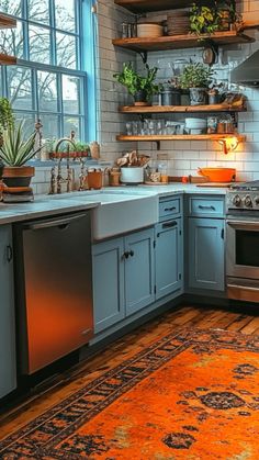 a kitchen with blue cabinets and an orange rug