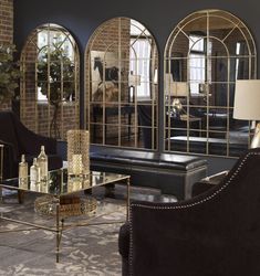 a living room filled with furniture and mirrors