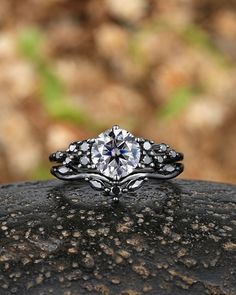 a diamond ring sitting on top of a rock