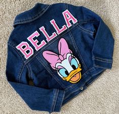 CUSTOM EMBELLISHED DENIM BABY/TODDLER/BIG KID'S DAISY DUCK PATCH JACKET (MONOGRAM/FULL NAME) COMES WITH 1 LARGE DAISY DUCK PATCH AND A 3 LETTER MONOGRAM/FULL NAME  Letter colors available, please specify: Red Black Pink Purple SIZES: Baby/Toddler  9-12 months  12-18 months 18-24 months  2T 3T 4T 5T Kids 4 xsmall 5/6 small 7/8 medium 10/12 large 14 x-large 16 xx-large    Notes: All sales final I don't accept returns, exchanges, or cancellations But please contact me if you have any problems with your order. Order takes up to 2 weeks to make based on demand but once shipped will arrive based on priority mail flat rate shipping times  Tracking information will be provided  WASH & CARE I have made the jacket with love now treat it the same to keep it looking its best! Wash inside out on a Cold Cute Fitted Blue Denim Jacket, Denim Patch Jacket, Disney Inspiration, 3 Letter Monogram, Large Daisy, Denim Baby, Patch Jacket, Denim Jacket Patches, Sequin Patch