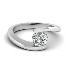 The Solitaire diamond engagement ring portrays an alluring round cut diamond at the center, held by the two metallic corners in an elegant tension setting. The smooth glossy finish of the diamond ring adds a contrasting effect to the brilliance of the center stone excellently.   The solitaire diamond engagement ring can also be acquired in a wide variation of metals. Free shipping within USA. Natural Conflict Free Diamonds. 30 Days Return Policy with Lifetime Upgrade.  Buy now and pay later with our Easy financing plan. Purchase your jewelry at source price, liberated from broker charges, trader charges, wholesalers or retailers charges.  The norms of Kimberley Process Certification System (KPCS) are followed by Fascinating Diamonds to provide you with the genuine confl Swirl Engagement Rings, Platinum Necklace, Engagement Ring Pictures, 2 Carat Engagement Ring, Tension Setting, Lab Diamond Engagement Ring, Solitaire Setting, Round Diamond Ring, Wedding Rings Solitaire