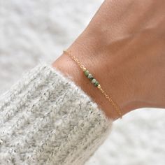 "This hand made bracelet showcases a stunning selection of raw emerald rondelles, centered on a dainty but durable chain in your preferred finish. This makes a wonderful gift for someone with a May birthday. Bracelet Size Guide: Petite: 6.5\"-7\" Average (fits most wrists): 7-8\" Large: 8-8.5\" To find your bracelet size, simply measure the circumference of your wrist by wrapping a string around it and measuring the length of the string. If you are shopping for someone else and are unsure of wha Raw Emerald, May Birthday, Birthday Bracelet, Emerald Bracelet, Birthstone Bracelet, May Birthstone, Minimal Jewelry, Jewelry For Her, Crystal Bracelet