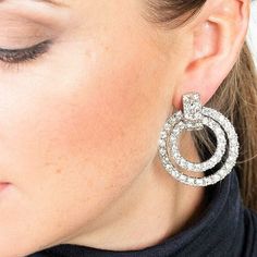 Add some sparkle to your season in our Kenneth Jay Lane Crystal Door Knocker Clip Earrings. These beautiful designer Kenneth Jay Lane doorknocker earrings are set in polished rhodium and finished with stunning crystal pave stones. Perfect for special events and more. A must have for cocktail season. Clip on 1.5" L Made in the USA SKU: KJL-1DRKC Glamorous Diamond Sparkling Hoop Earrings, Glamorous Diamond Hoop Earrings With Sparkling Stones, Glamorous Hoop Earrings With Sparkling Stones For Anniversary, Luxury Sparkling Diamond Earrings For Parties, Glamorous Round Diamond Crystal Earrings, Silver Sparkling Earrings For Glamorous Events, Sparkling Silver Earrings For Glamorous Events, Silver Cubic Zirconia Earrings For Glamorous Events, Glamorous Diamond Bling Earrings