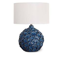 a blue ceramic lamp with a white shade