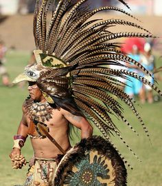 a native american man dressed in an elaborate headdress