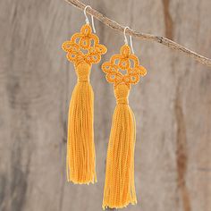 Carrying an antique aesthetic, these luxurious dangle earrings are created by Guatemalan artisan Gladys Pichola. She utilizes traditional tatting techniques, where she diligently crochets the earrings of nylon thread, featuring a sunny marigold color. An elegant tassel dangles from each earring, which is suspended from a sterling silver hook. Marigold Color, Traditional Aesthetic, Hand Tats, Antique Aesthetic, Red Petals, Lace Earrings, Bold Earrings, Pumpkin Colors, Fall Earrings