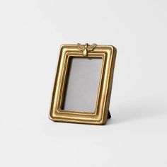 a gold frame sitting on top of a white table