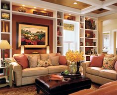 a living room filled with furniture and lots of bookshelves on the wall behind it