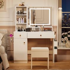 a bedroom with a vanity, mirror and stool in it's corner next to a window