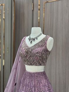 Our stunning Net Fabric Party Wear Lehenga in striking purple is perfect for making a bold statement at any special occasion, featuring intricate embroidery work in gold and silver threads. Elegant Semi-stitched Purple Sets, Elegant Purple Sets With Intricate Embroidery, Elegant Purple Set With Zari Work, Elegant Purple Sets With Zari Work, Elegant Purple Sets For Diwali, Party Gown In Art Silk With Intricate Embroidery, Party Gown With Intricate Embroidery In Art Silk, Elegant Purple Sets With Resham Embroidery, Festive Purple Sets With Intricate Embroidery