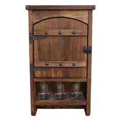 an old wooden cabinet with three glasses on the bottom and one door open to reveal it's contents