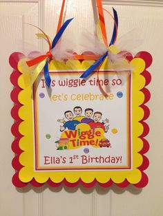 a birthday card hanging on a door with ribbon around it's edges and an orange, yellow, and red frame